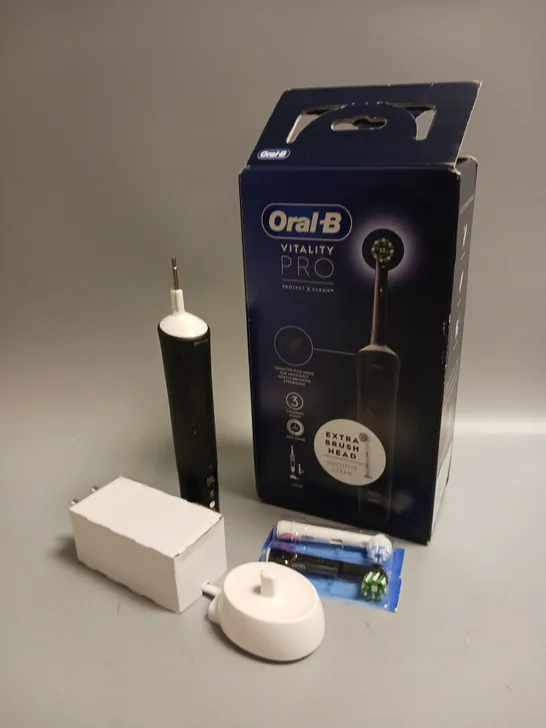 BOXED ORAL B VITALITY PRO ELECTRIC TOOTHBRUSH IN BLACK AND WHITE INCLUDES CHARGING STAND AND 2 BRUSH HEADS