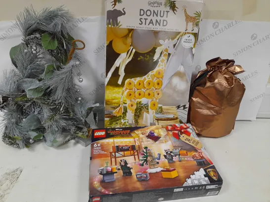 APPROXIMATELY 7 ASSORTED PRODUCTS TO INCLUDE; CHOCOHOLICS CHOICE GIFT HAMPER, LETS GO WILD GIRAFFE DOUGHNUT STAND, CADBURYS DAIR MILK CAR, LIT CONE GARLAND, RAVENHEAD ESSENTIALS FLOWER SET OF 2 AND GU RRP £163