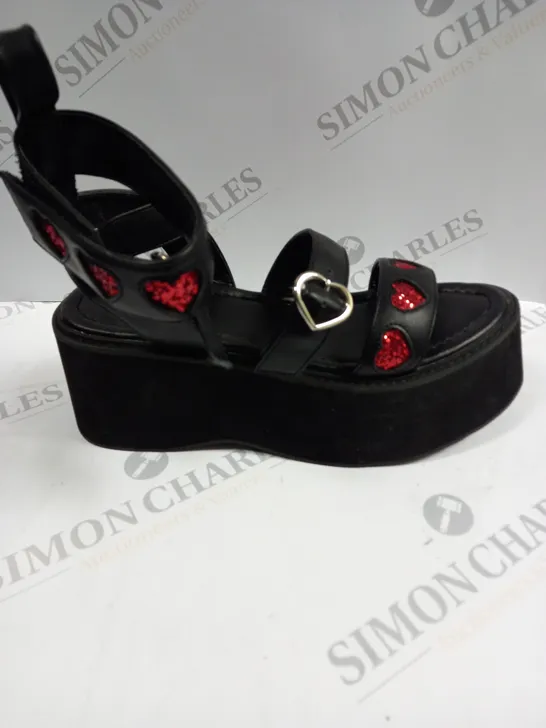 PAIR OF KOI FOOTWEAR ROGUE LOVERGIRL FLATFORM HEART BLACK SANDALS - SIZE UNSPECIFIED 