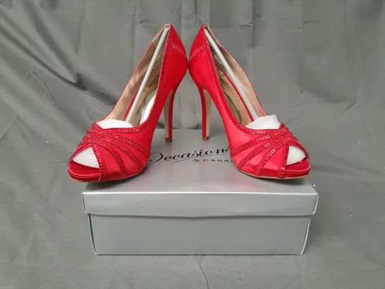 BOX OF APPROXIMATELY 10 BOXED PAIRS OF OCCASIONS BY CASANDRA PEEP TOE HIGH HEEL SHOES IN RED SATIN W. JEWEL EFFECT - VARIOUS SIZES