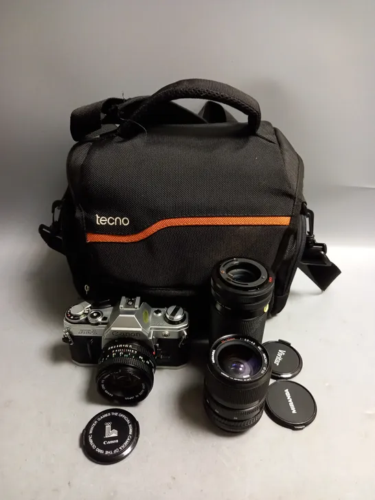 CANON AE-1 SLR CAMERA WITH 2 SPARE LENSES AND TECNO CAMERA BAG