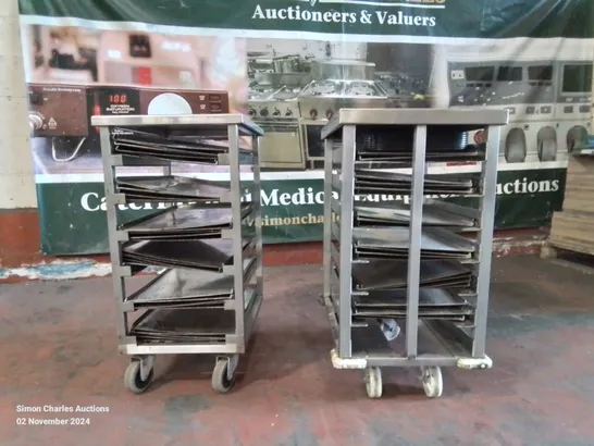 PAIR OF STAINLESS STEEL COMMERCIAL COOKING TRAY TROLLEYS WITH LARGE AMOUNT OF METAL OVEN TRAYS