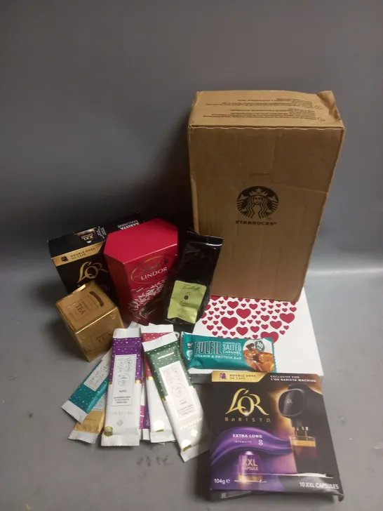 TOTE OF APPROX 12 ASSORTED FOOD ITEMS TO INCLUDE - STARBUCKS NESPRESSO COFFEE CAPSULES - PURE HEAVENLY CHOCOLATE BARS - LINDT MILK CHOCOLATE ETC