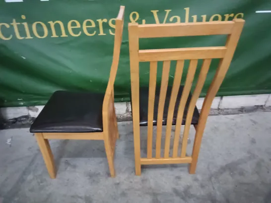 PAIR OF WOODEN DINING CHAIRS WITH BLACK FAUX LEATHER SEAT PADS 