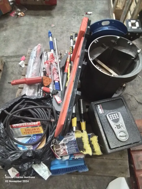 PALLET CONTAINING VARIOUS BROKEN/INCOMPLETE TOOLS TO INCLUDE: AIR HOSES, WHEEL NUT BREAKER BARS, SAFE, CAST IRON STOVE ETC.