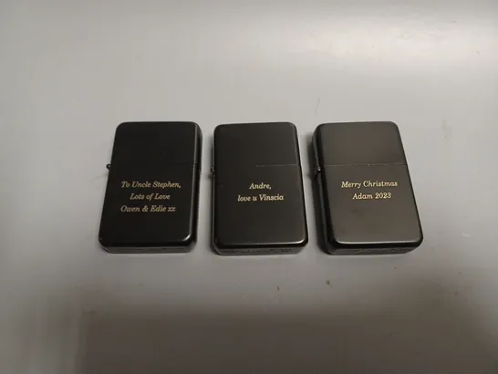 THREE ASSORTED ENGRAVED BLACK LIGHTERS RRP £29.97