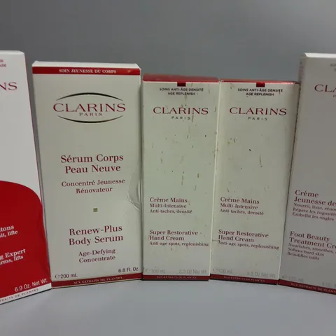 LOT OF 5 CLARINS PARIS BEAUTY ITEMS TO INCLUDE BODY SERUM, HAND CREAM AND BODY FIT