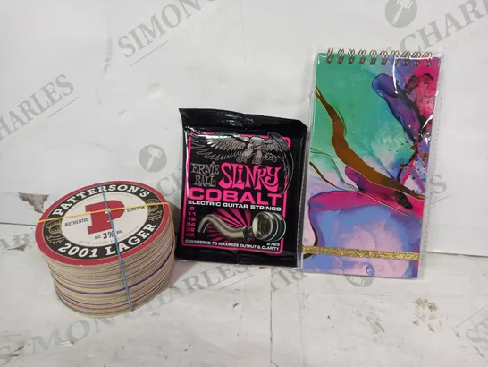 LOT OF APPROXIMATELY 15 ASSORTED HOUSEHOLD ITEMS TO INCLUDE NOTEBOOK, ERNIE BALL GUITAR STRINGS, COASTERS, ETC