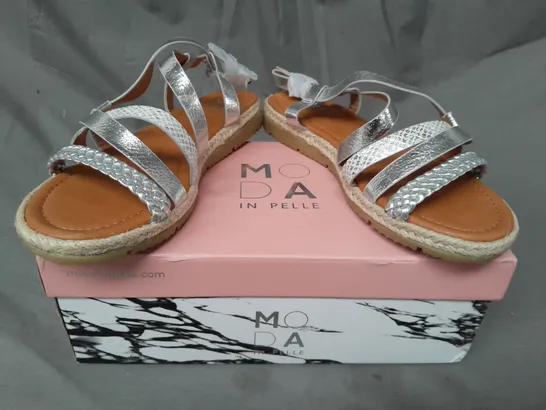 BOXED PAIR OF MODA IN PELLE PLAITED DETAIL FLAT OPEN TOE SANDALS IN METALLIC SILVER EU SIZE 37