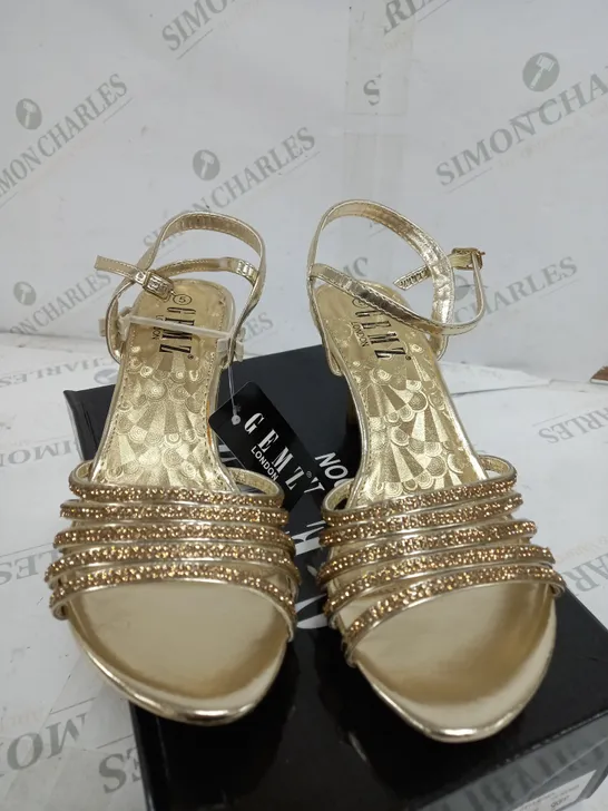 BOX OF APPROXIMATELY 5 GEMZ LONDON GOLD GEM HEELS 