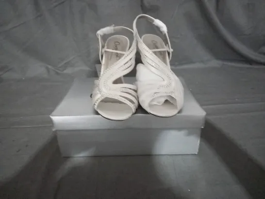 APPROXIMATELY 12 BOXED PAIR OF CASANDRA IVORY HEELED SANDALS IN VARIOUS SIZES TO INCLUDE SIZE 5