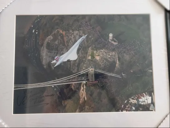 FRAMED AND MOUNTED PHOTOGRAPH OF  THE CONCORDE ON ITS LAST-EVER FLIGHT, OVER THE CLIFTON SUSPENSION BRIDGE IN BRISTOL, WESTERN ENGLAND BY LEWIS WHYLD SIGNED BY CHIEF PILOT CAPTAIN MIKE BANNISTER