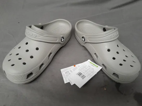 PAIR OF CROCS CLASSICS IN GREY UK SIZE M6/W7