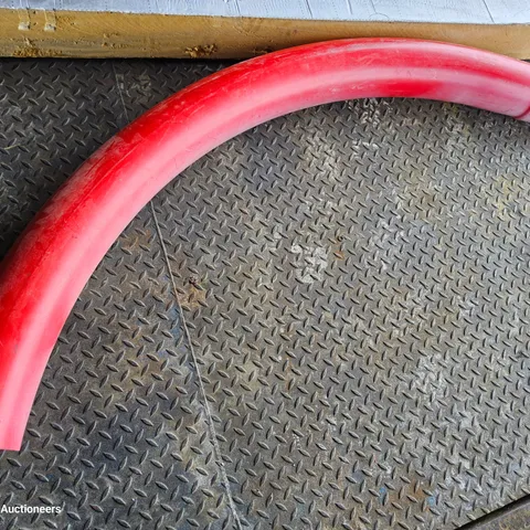 CURVED SECTION OF RED PLASTIC ELECTRICITY CABLE DUCTING