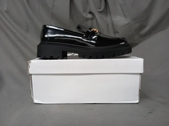 BOXED PAIR OF TRUFFLE COLLECTION LOAFERS IN GLOSSY BLACK W. GOLD EFFECT DETAIL SIZE 5