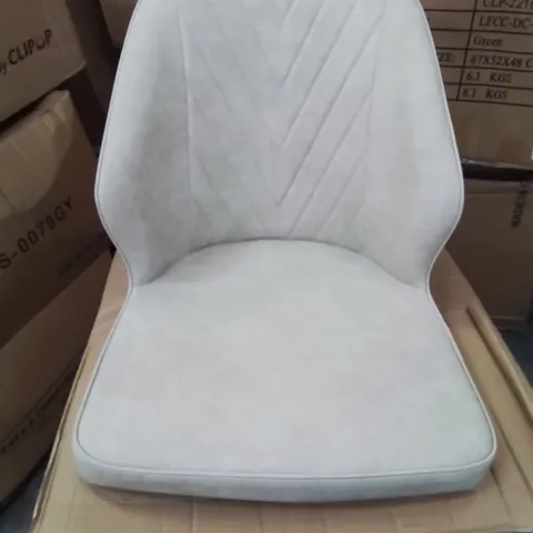 A BOXED PAIR OF CREAM FAUX LEATHER UPHOLSTERED SIDE CHAIRS