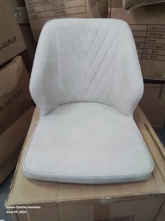 A BOXED PAIR OF CREAM FAUX LEATHER UPHOLSTERED SIDE CHAIRS