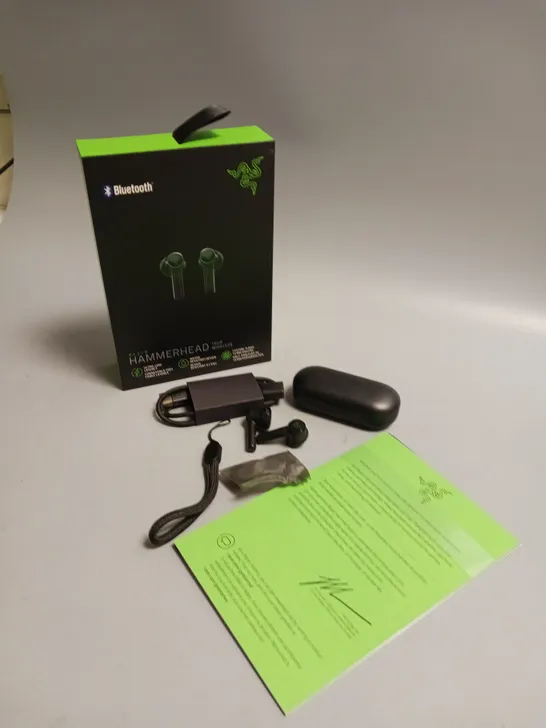 LOT OF 5 BOXED RAZER WIRELESS HEADPHONES IN BLACK AND GREEN INCLUDES CHARGING CASE, CABLE, WRIST STRAP AND SPARE BUDS