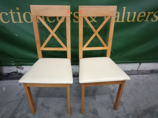 PAIR OF WOODEN DINING CHAIRS WITH CREAM FAUX LEATHER SEAT PADS 