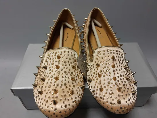 APPROXIMATELY 13 CASANDRA SPIKED SLIPONS IN CHAMPAGNE SATIN IN VARIOUS SIZES