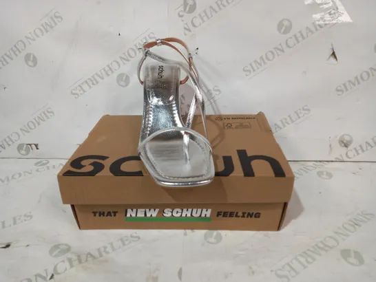 BOXED PAIR OF SCHUH HEELED SANDALS IN METALLIC SILVER COLOUR UK SIZE 7