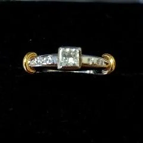18CT GOLD RING SET WITH A NATURAL PRINCESS CUT DIAMOND AND NATURAL DIAMONDS TO SHOULDERS