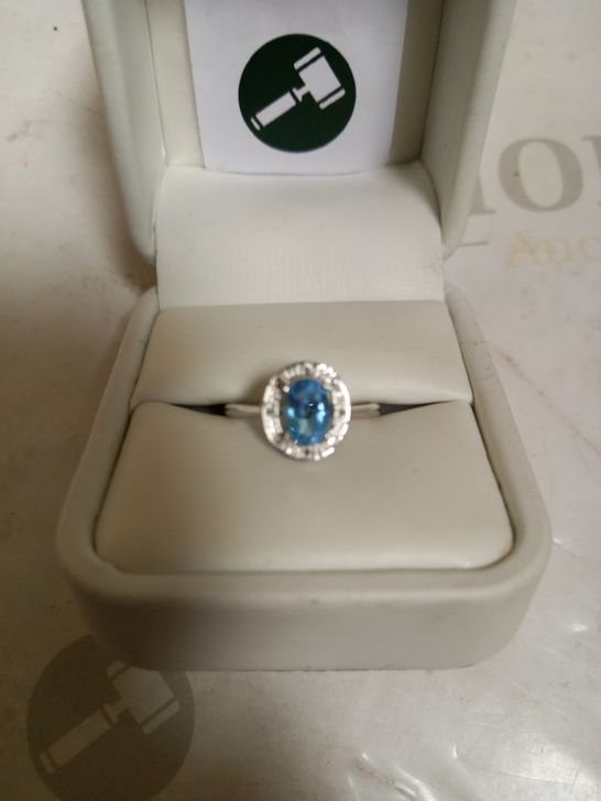 9CT WHITE GOLD DRESS RING SET WITH AN OVAL BLUE TOPAZ TO DIAMOND HALO, TOTAL WEIGHT +0.90CT