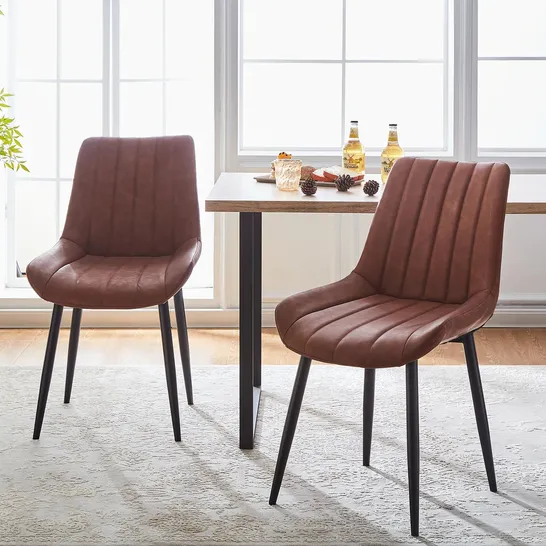 A BOXED PAIR OF BROWN FAUX LEATHER UPHOLSTERED DINING CHAIRS