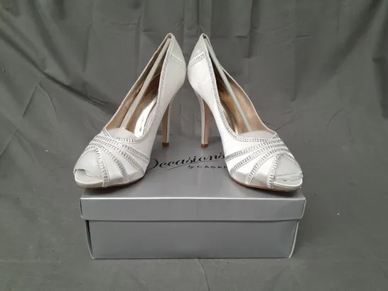 BOX OF APPROXIMATELY 10 BOXED PAIRS OF OCCASIONS BY CASANDRA PEEP TOE HIGH HEEL SHOES IN IVORY SATIN W. JEWEL EFFECT - VARIOUS SIZES