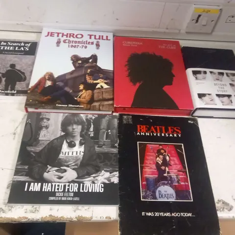 APPROXIMATELY SIX ASSORTED MUSIC BOOKS TO INCLUDE; BEATLES ANNIVERSARY MAGAZINE, JETHRO TULL CHRONICLES 1967-79, CUREPEDIA, BTS BEYOND THE STORY, I AM HATED FOR LOVING DICKIE FELTON AND IN SEARCH OF T