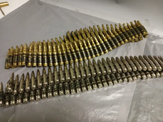 TWO STRIPS OF BULLETS ATTACHED TO BELTS