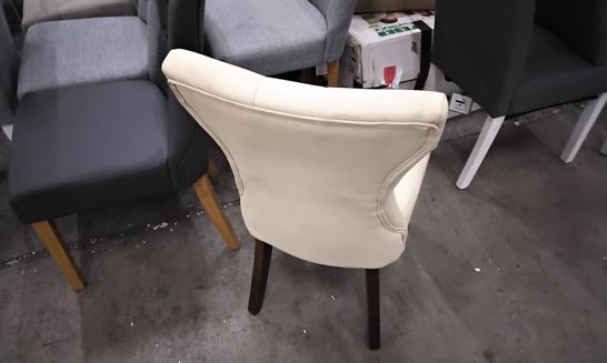 DESIGNER CREAM FAUX LEATHER DINING CHAIR WITH SHAPED BACK AND DARK BROWN LEGS 