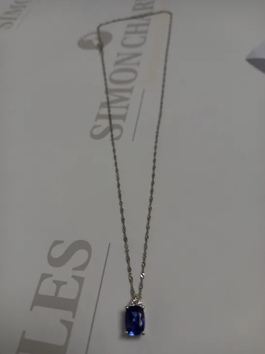 DESIGNER 18CT WHITE GOLD PENDANT ON A CHAIN, SET WITH AN OVAL CUT TANZANITE AND DIAMONDS WEIGHING +-1.44CT