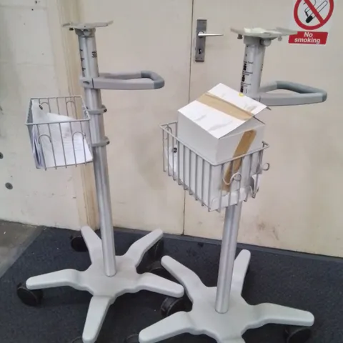 TWO GE HEALTHCARE WHEELED ADJUSTABLE MONITOR STANDS