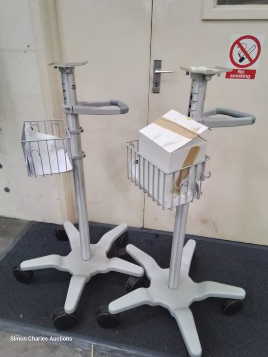 TWO GE HEALTHCARE WHEELED ADJUSTABLE MONITOR STANDS