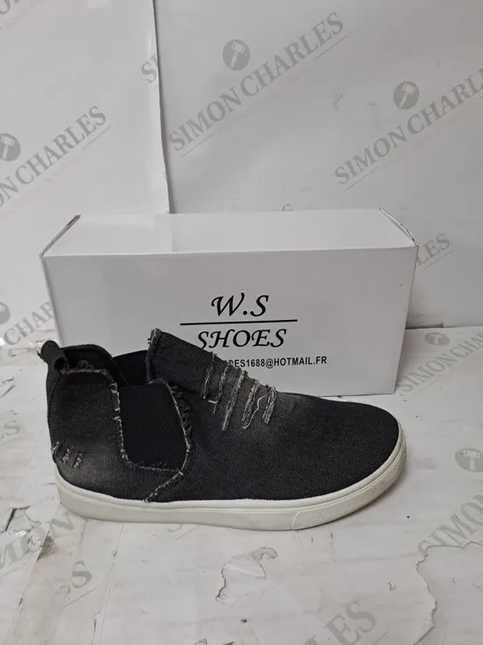 APPROXIMATELY 10 PAIRS OF BOXED W.S SLIP ON BLACK DISTRESSED FLAT TRAINERS IN VARIOUS SIZES