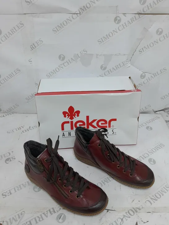 BOXED PAIR OF RIEKER SIDE ZIP WATER RESISTANT BOOTS IN BURGUNDY SIZE 6