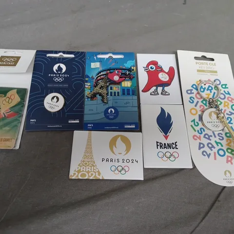 SEVEN ASSORTED ITEMS OF OLYMPICS MEMORBILIA TO INCLUDE; 2024 PIN BADGES, 2024 KEY RING AND 2024 FRIDGE MAGNETS