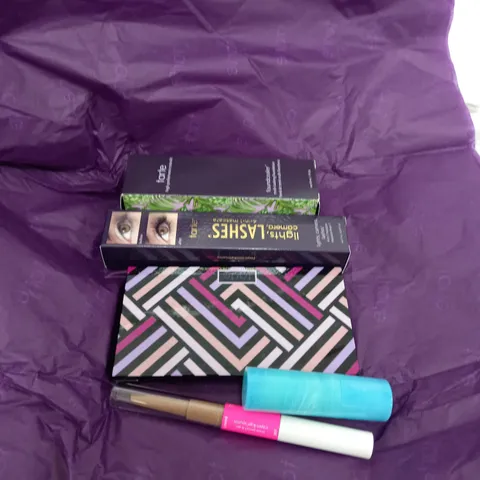 box of approximately 5 tarte beauty makeup products to include mascara, foundation eye and cheek pallet etc