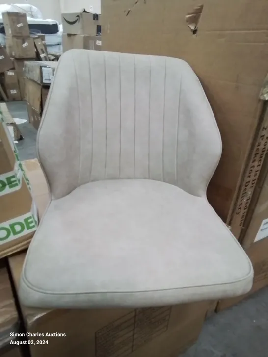 A BOXED PAIR OF CREAM FAUX LEATHER UPHOLSTERED SIDE CHAIRS 