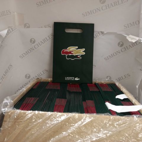 BOX OF APPROX 80 RED/GREEN/GOLD LACOSTE PARFUMS GIFT BAGS
