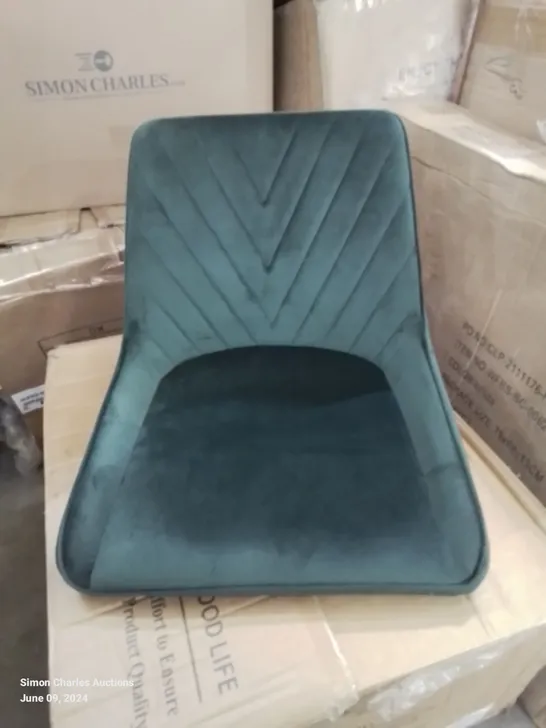 A BOXED PAIR OF GREEN VELVET UPHOLSTERED DINING ROOM CHAIRS 