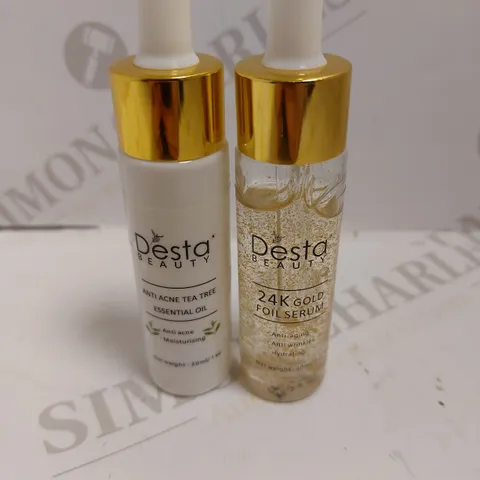 BOX OF 2 DESTA BEAUTY ITEMS TO INCLUDE ANTI ACNE TEA TREE ESSENTIAL OIL AND 24K GOLD FOIL SERUM