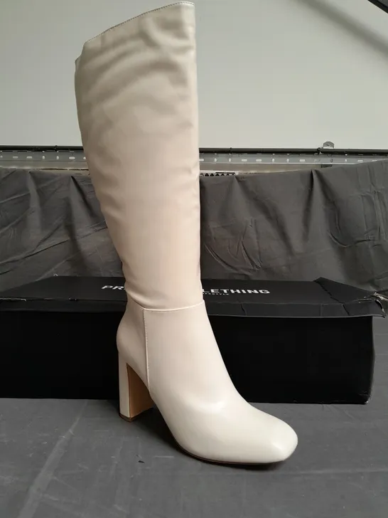 BOXED PAIR OF PRETTYLITTLETHING CREAM HEELED BOOTS SIZE UK 9