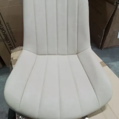 A BOXED PAIR OF FAUX LEATHER LIGHT TAN SIDE CHAIRS