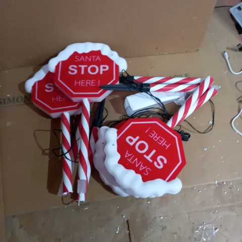 FESTIVE SET OF PRELIT SANTA STOP HERE STAKES