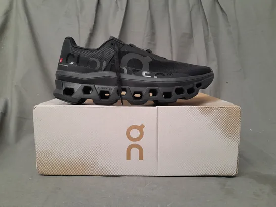 BOXED PAIR OF ON RUNNING CLOUDMONSTER TRAINERS IN BLACK UK SIZE 9