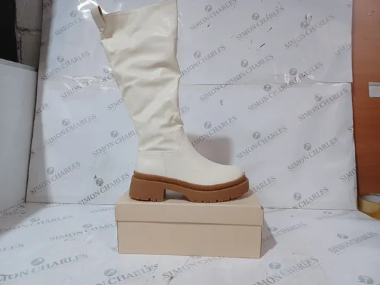 BOXED PAIR OF PUBLIC DESIRE JERSEY BOOTS IN CREAM UK SIZE 6