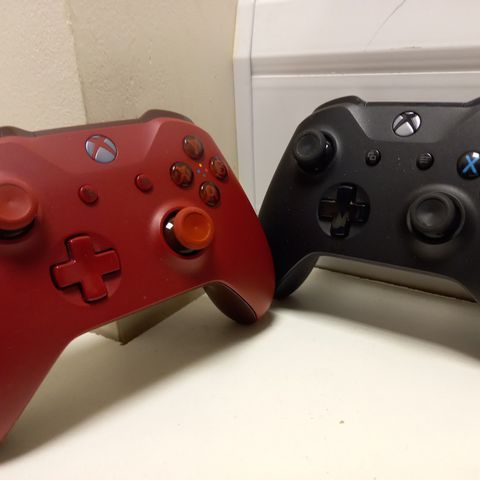 TWO XBOX CONTROLLERS, 1 X RED & 1 X BLACK
