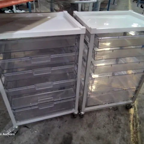 TWO METAL FRAMED TROLLEYS WITH 5 CLEAR PLASTIC GRADUATED TRAYS